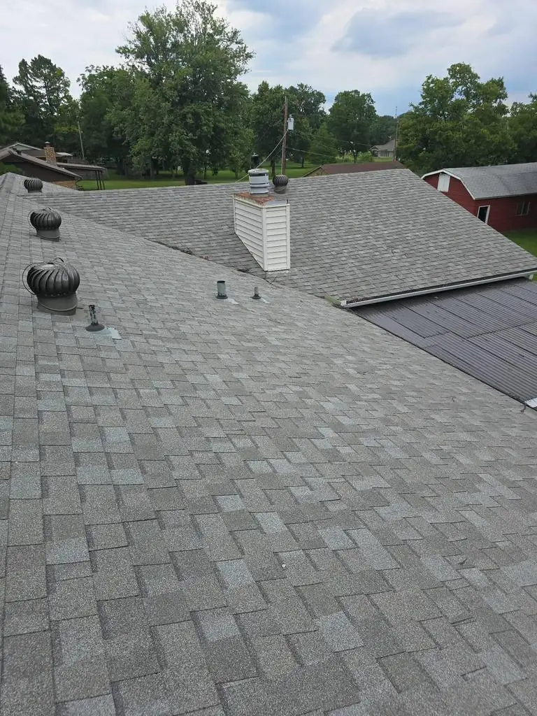 Roof work in progress with multiple sections visible